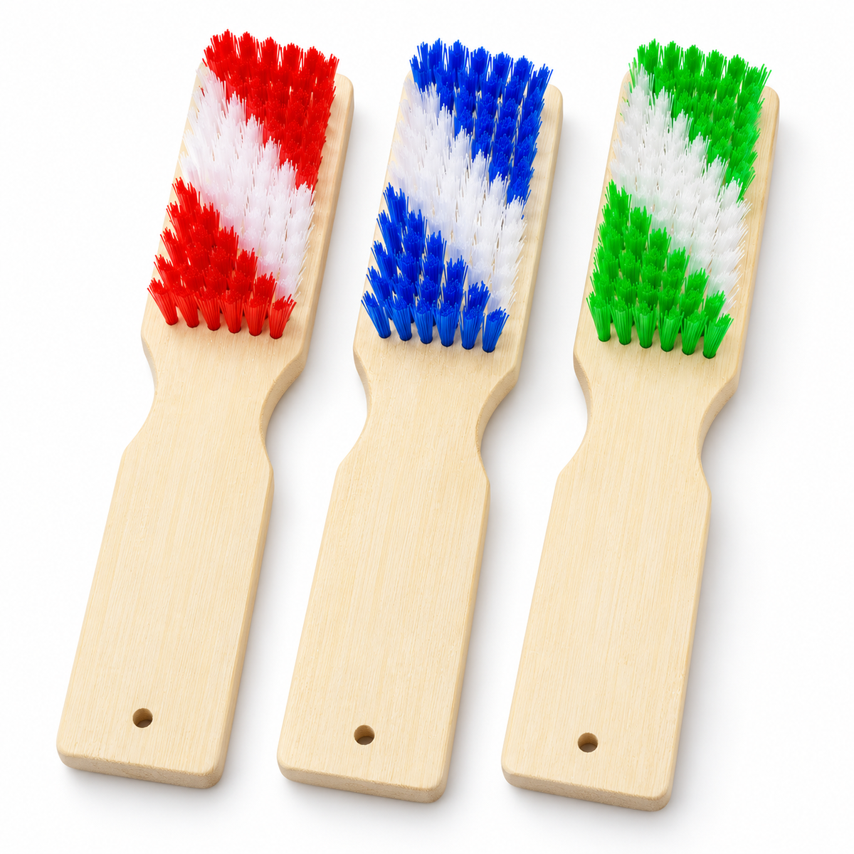 Three bamboo shoe brushes with red blue and green two-tone bristles on white.